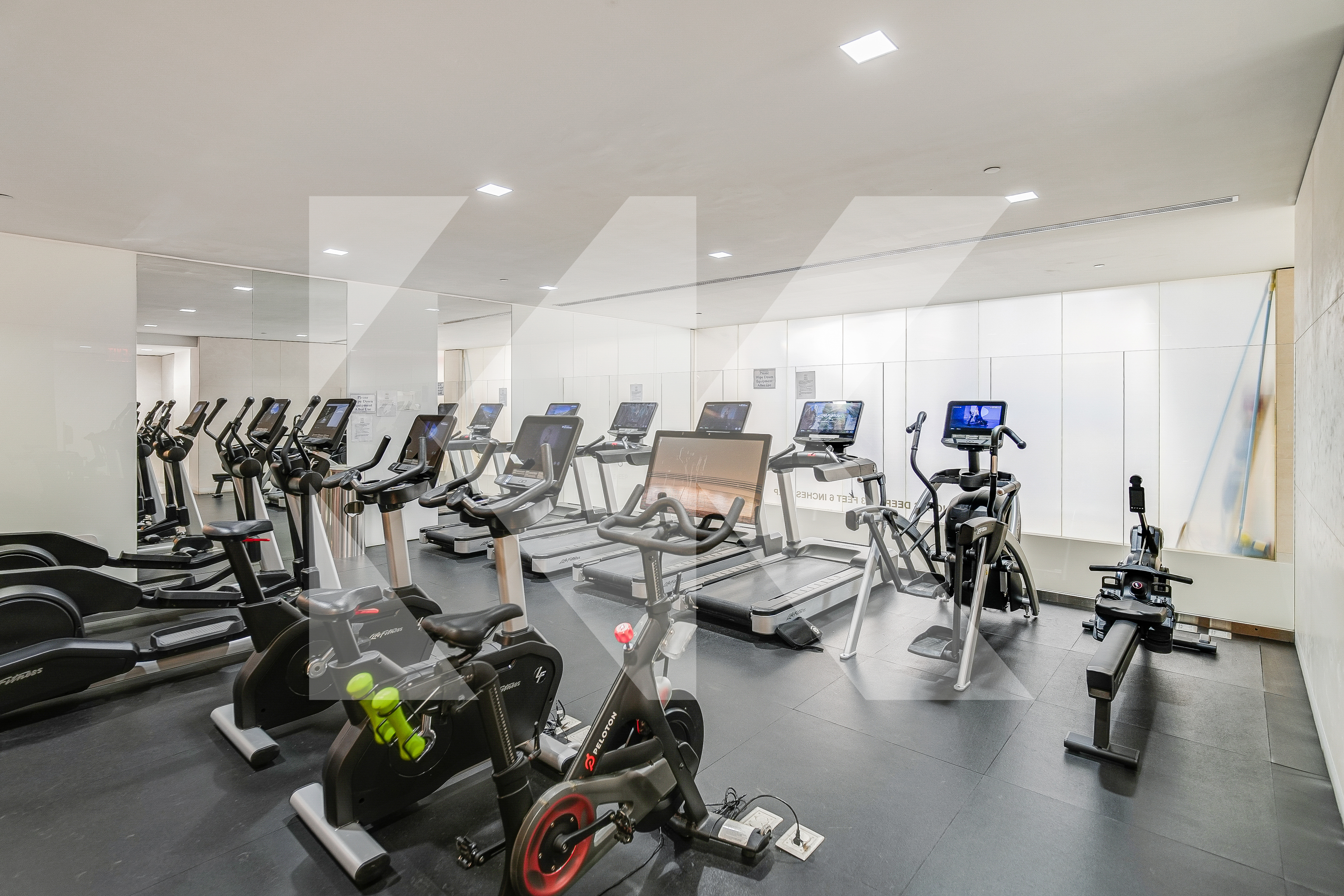 400 East 67th Street, Unit 3CD Manhattan, NY 10065 - Photo 15 of 28 a room with gym equipment and large mirror