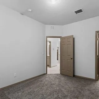 an empty room with closet area