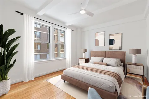 a bedroom with a bed and a potted plant