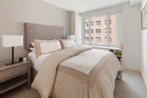 a spacious bedroom with a bed and a window