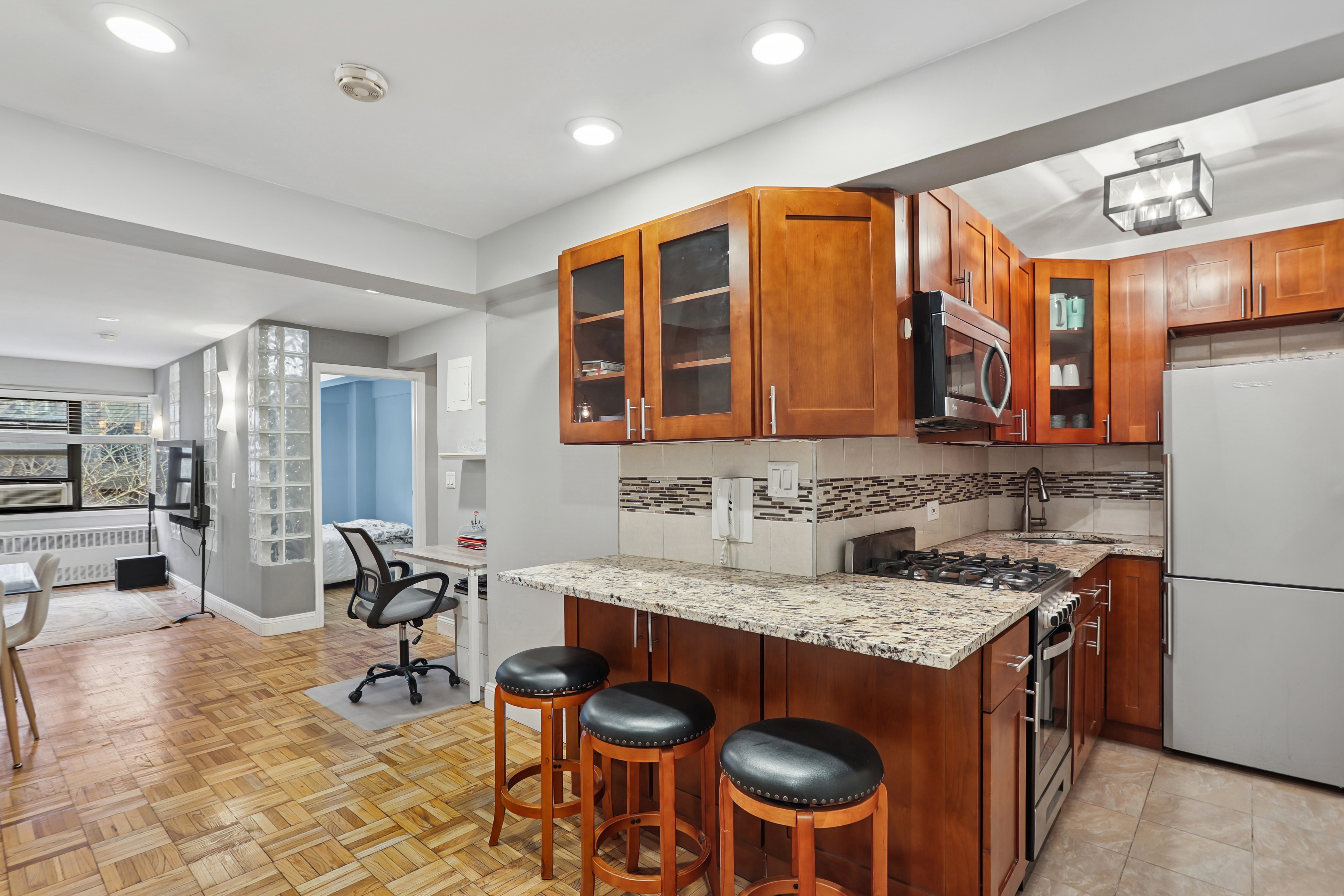 335 East 51st Street, Unit 4H Manhattan, NY 10022 - Photo 1 of 13 a kitchen with stainless steel appliances granite countertop a stove and a sink