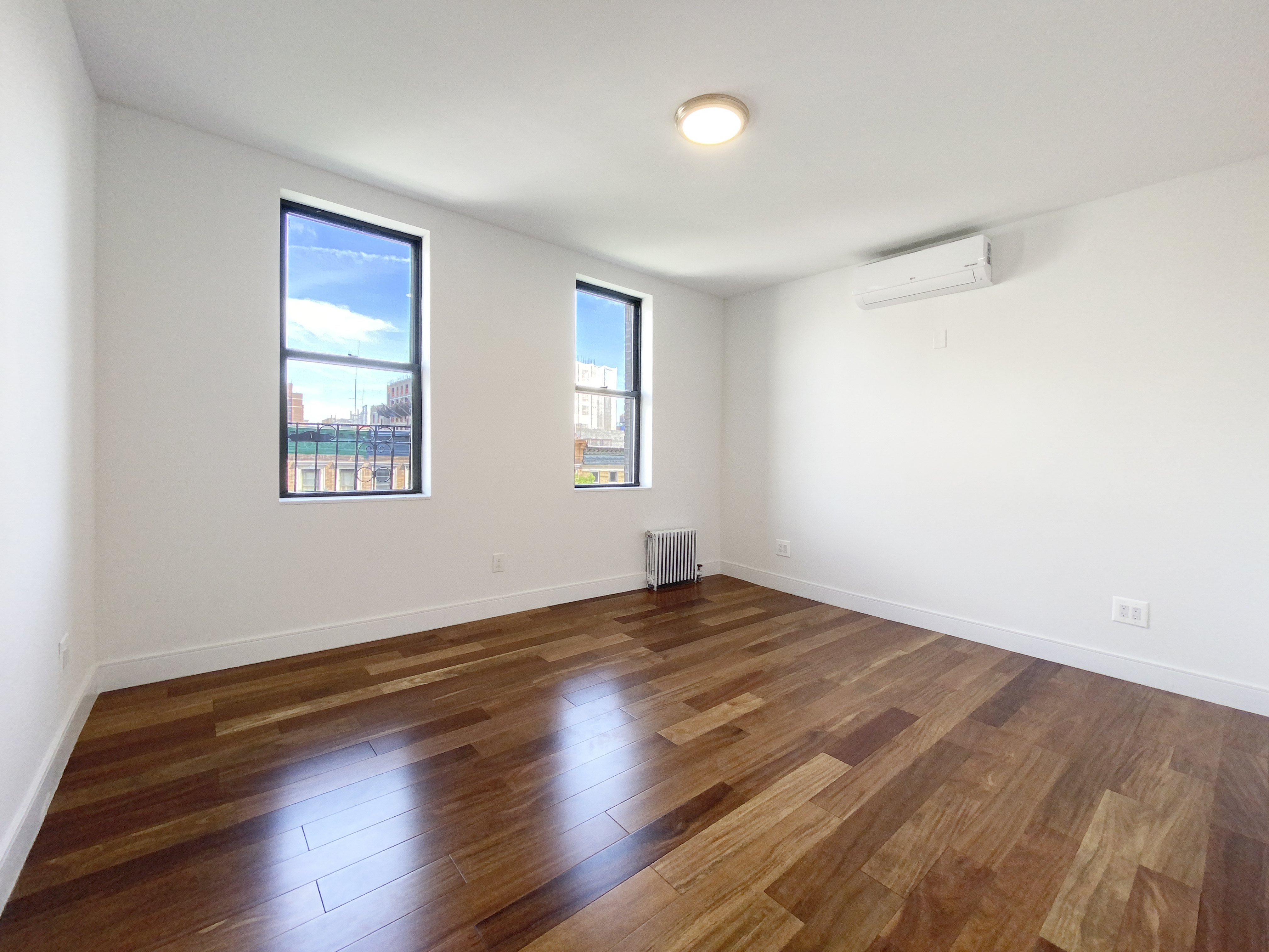 200 West 109th Street, Unit E4 Manhattan, NY 10025 - Photo 8 of 13 a view of an empty room with wooden floor and a window