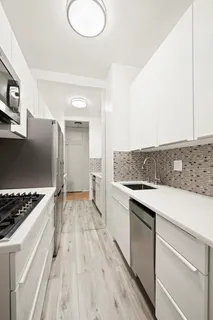 a kitchen with a sink stove and cabinets