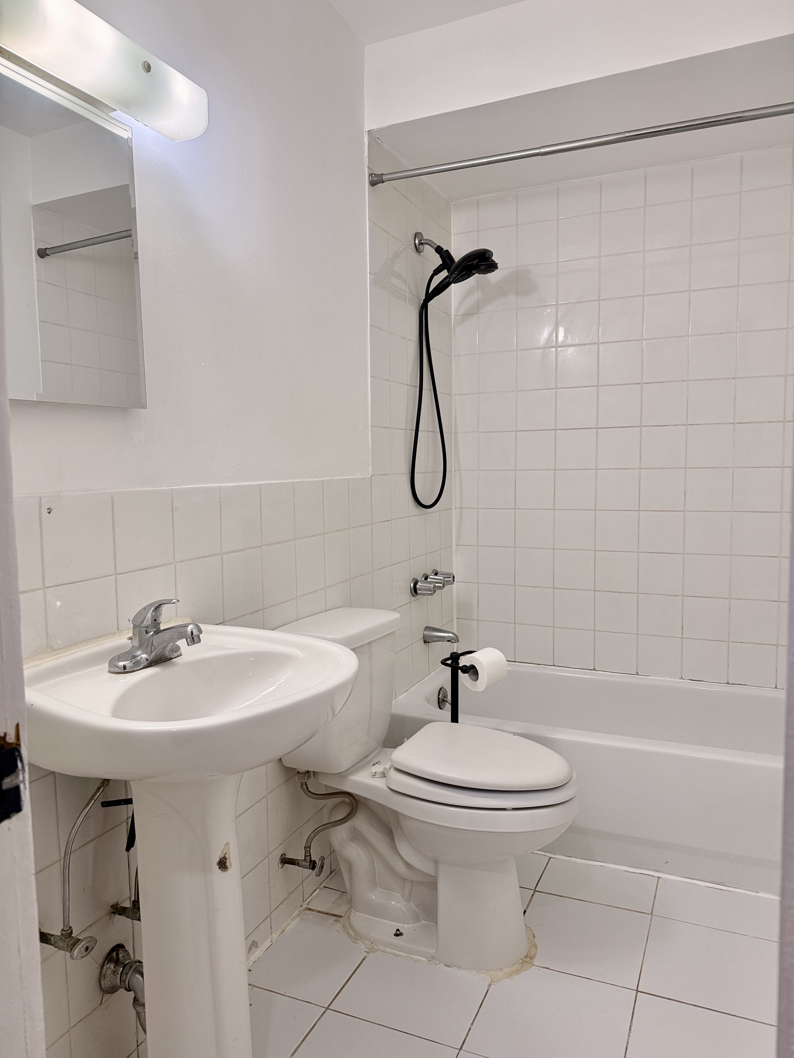 1997 3rd Avenue, Unit 1A Manhattan, NY 10029 - Photo 14 of 23 a bathroom with a sink a toilet and shower