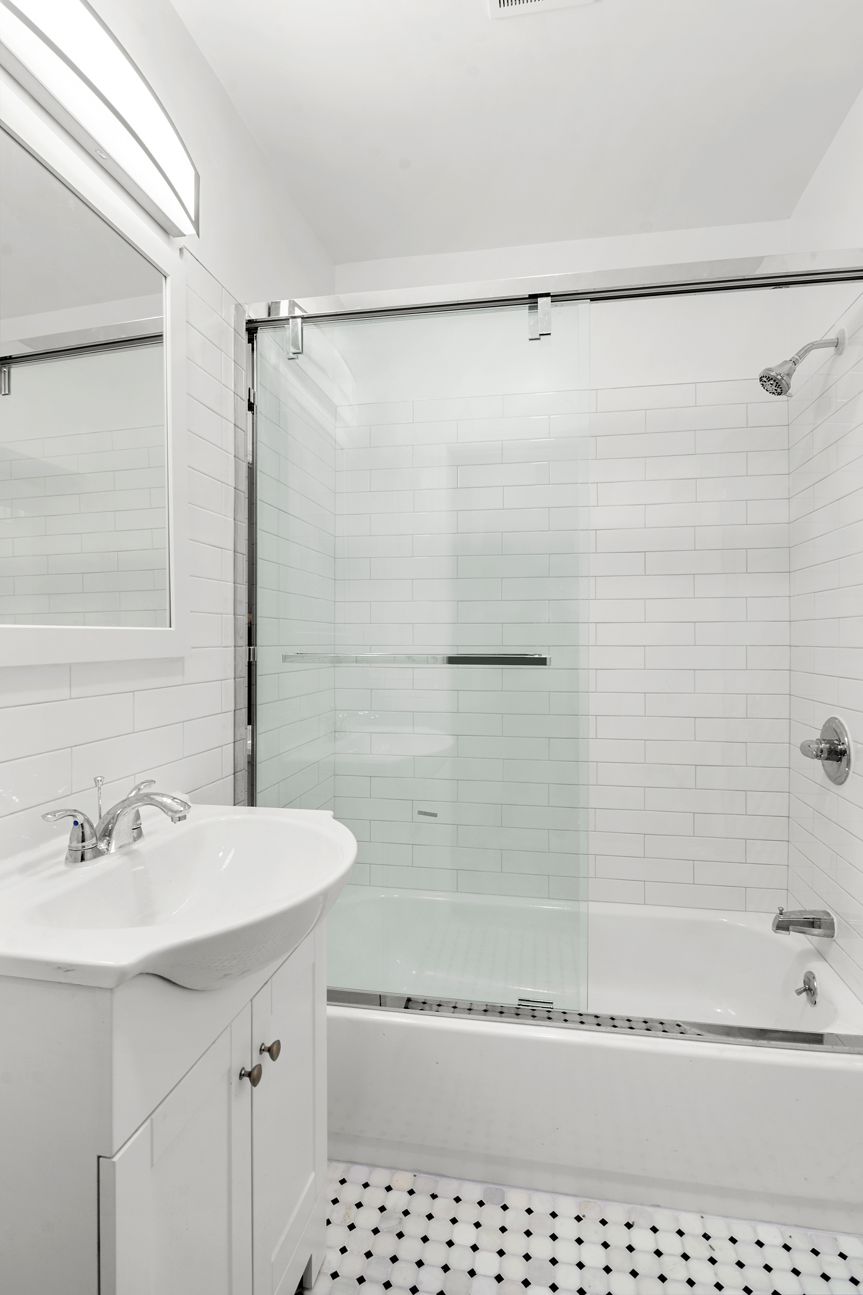955 Pacific Street, Unit 1 Brooklyn, NY 11238 - Photo 7 of 12 a bathroom with a sink a mirror and a shower