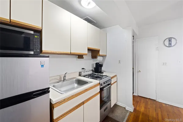 a kitchen with a sink stove and microwave