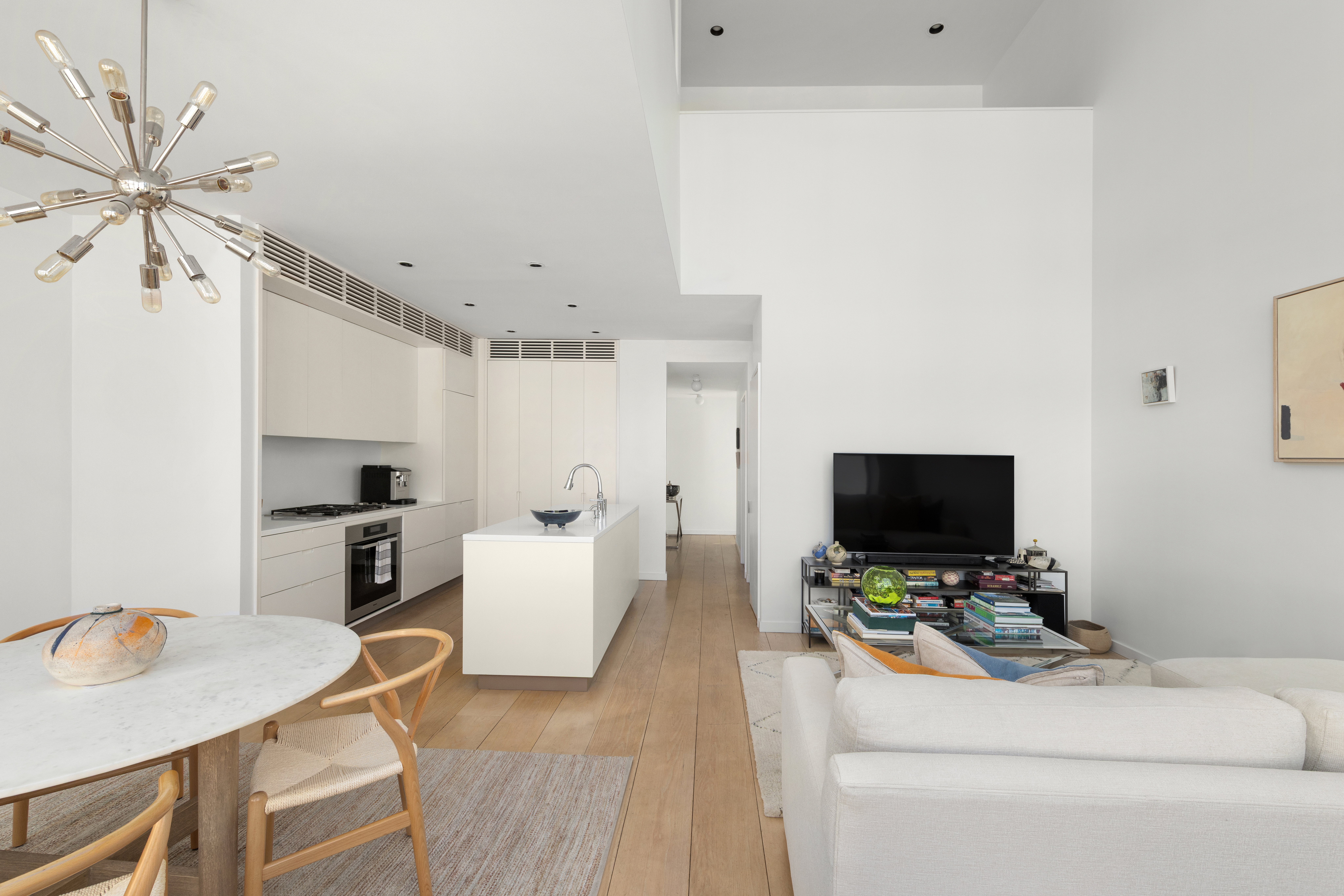 456 West 19th Street, Unit 4/5A Manhattan, NY 10011 - Photo 8 of 15 a living room with furniture and a flat screen tv