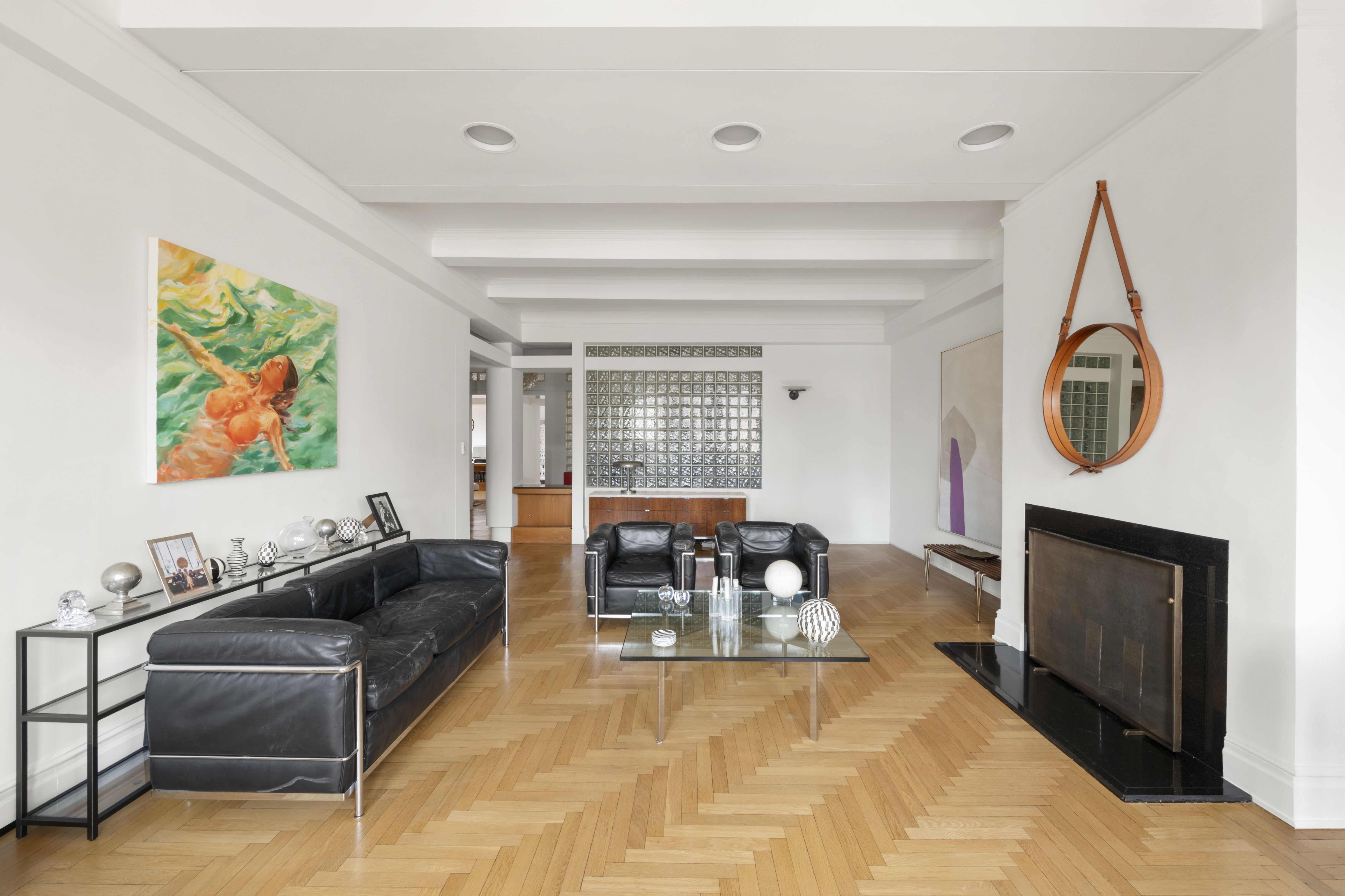 911 Park Avenue, Unit 14C Manhattan, NY 10075 - Photo 2 of 18 a living room with furniture a fireplace and a flat screen tv