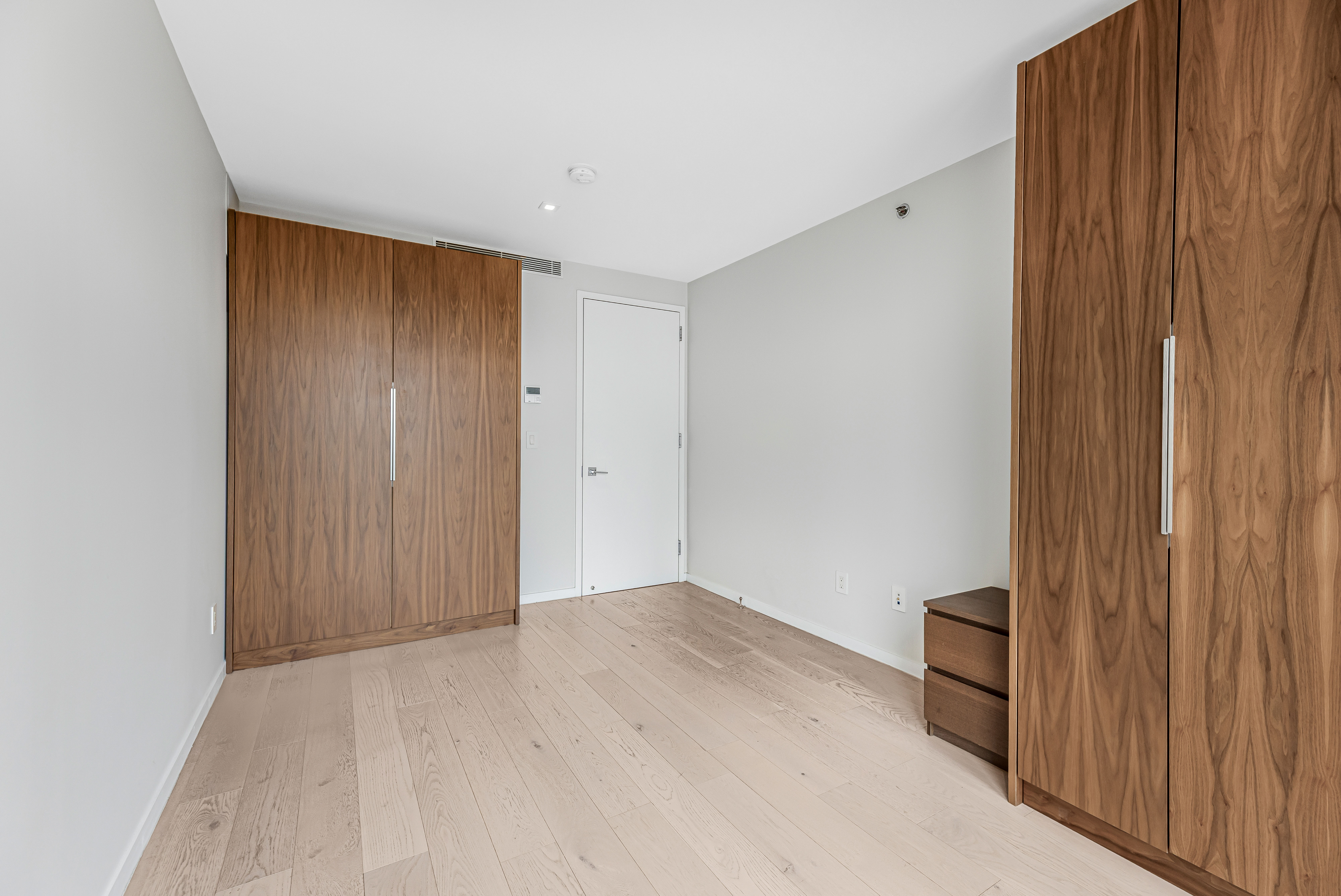 42-50 27th Street, Unit 9C Queens, NY 11101 - Photo 8 of 32 a view of an empty room with wooden floor