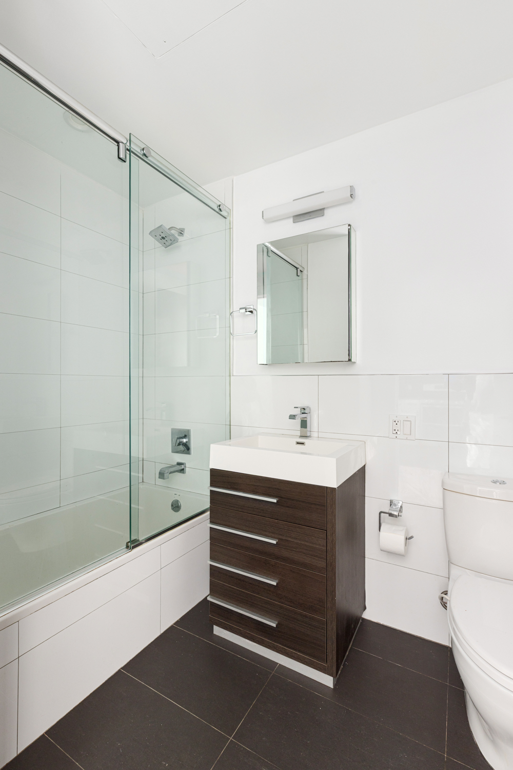 74 Adelphi Street, Unit 2B Brooklyn, NY 11205 - Photo 7 of 9 a bathroom with a sink and a mirror