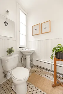 a bathroom with a toilet a sink and a window