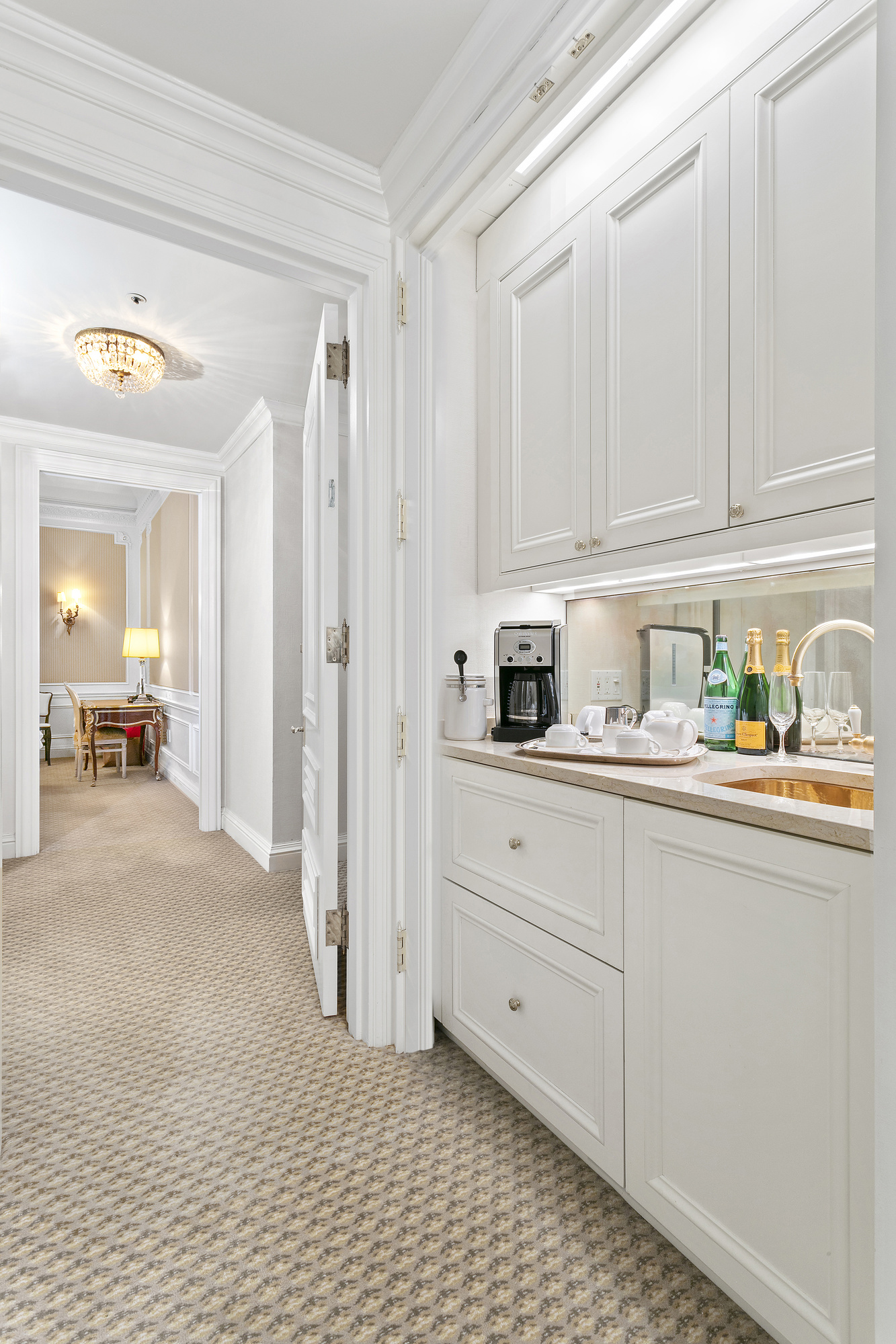 2 East 55th Street, Unit 1116 Manhattan, NY 10022 - Photo 4 of 14 a kitchen with white cabinets and sink