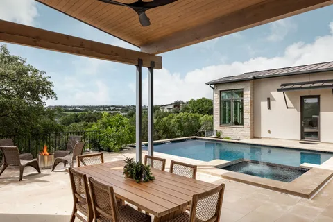 a view of a patio with table and chairs and potted plants