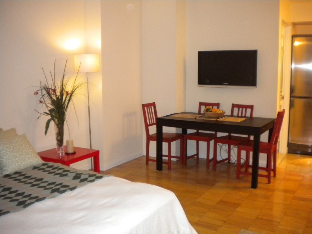 45 East 25th Street, Unit 12E Manhattan, NY 10010 - Photo 4 of 5 a bedroom with a bed and a flat screen tv