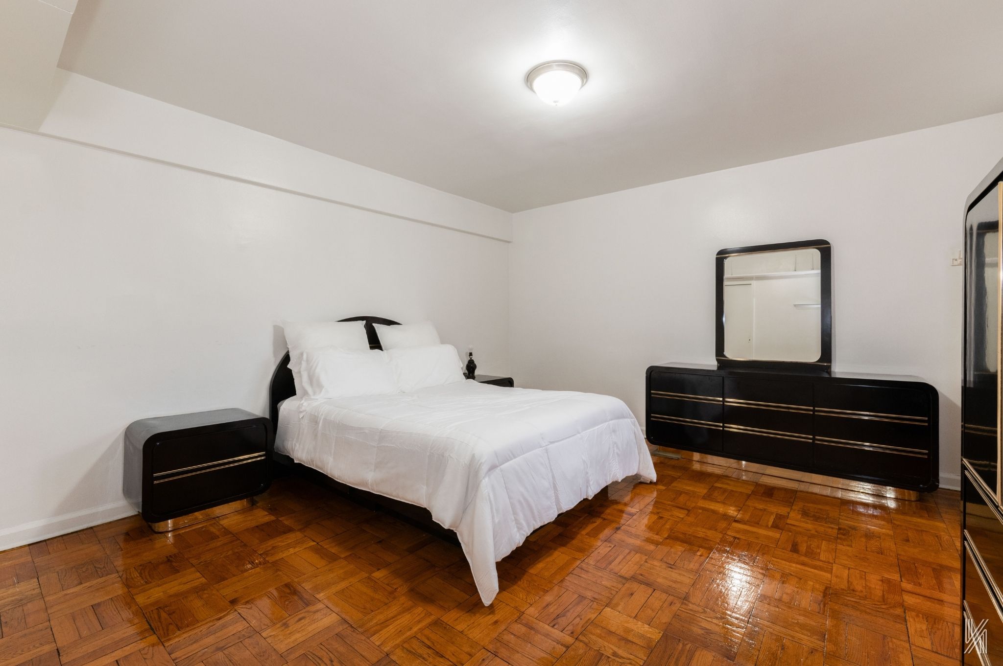 33-24 Junction Boulevard, Unit 1R Queens, NY 11372 - Photo 10 of 17 a bedroom with a bed and wooden floor