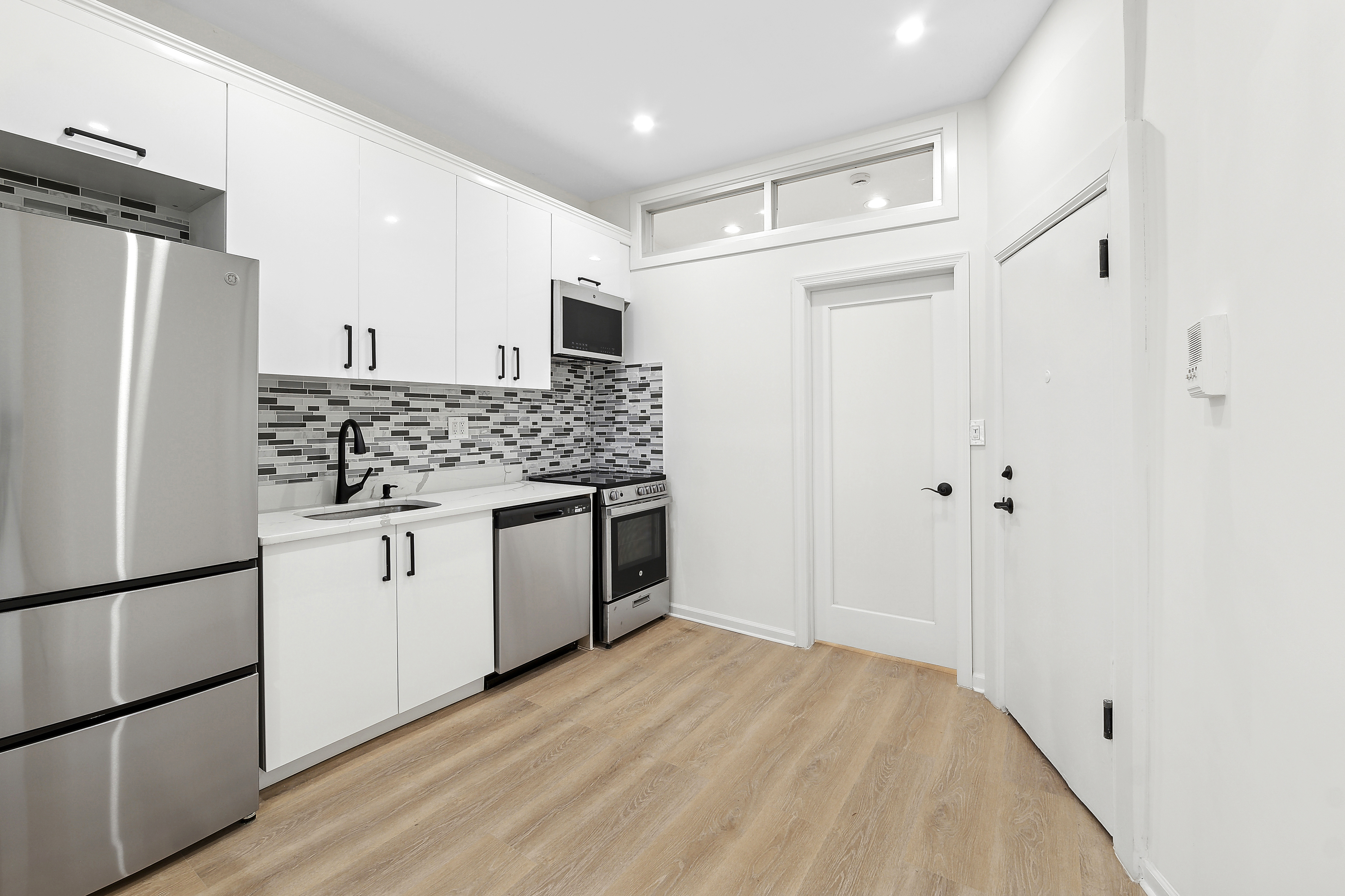 398 3rd Avenue, Unit 4B Manhattan, NY 10016 - Photo 4 of 10 a kitchen with stainless steel appliances a refrigerator and a stove top oven