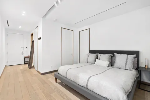 a bedroom with a bed and a walk in closet