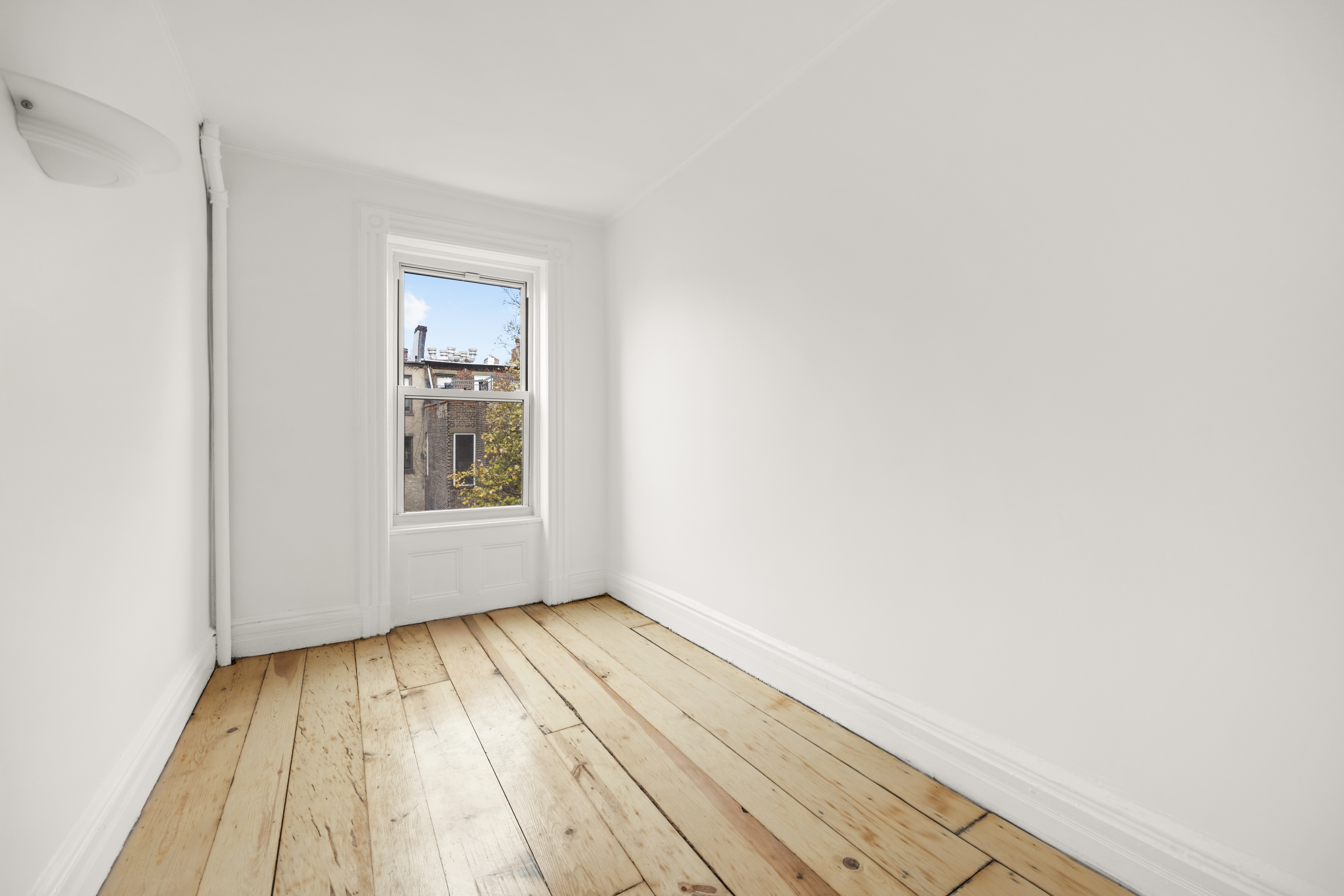485 1st Street, Unit 2 Brooklyn, NY 11215 - Photo 11 of 17 a view of an empty room with wooden floor and a window