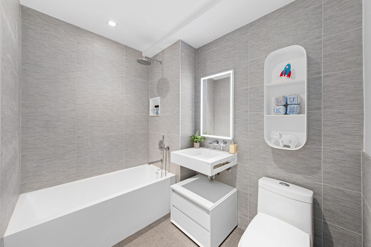 a bathroom with a toilet a sink and bath tub