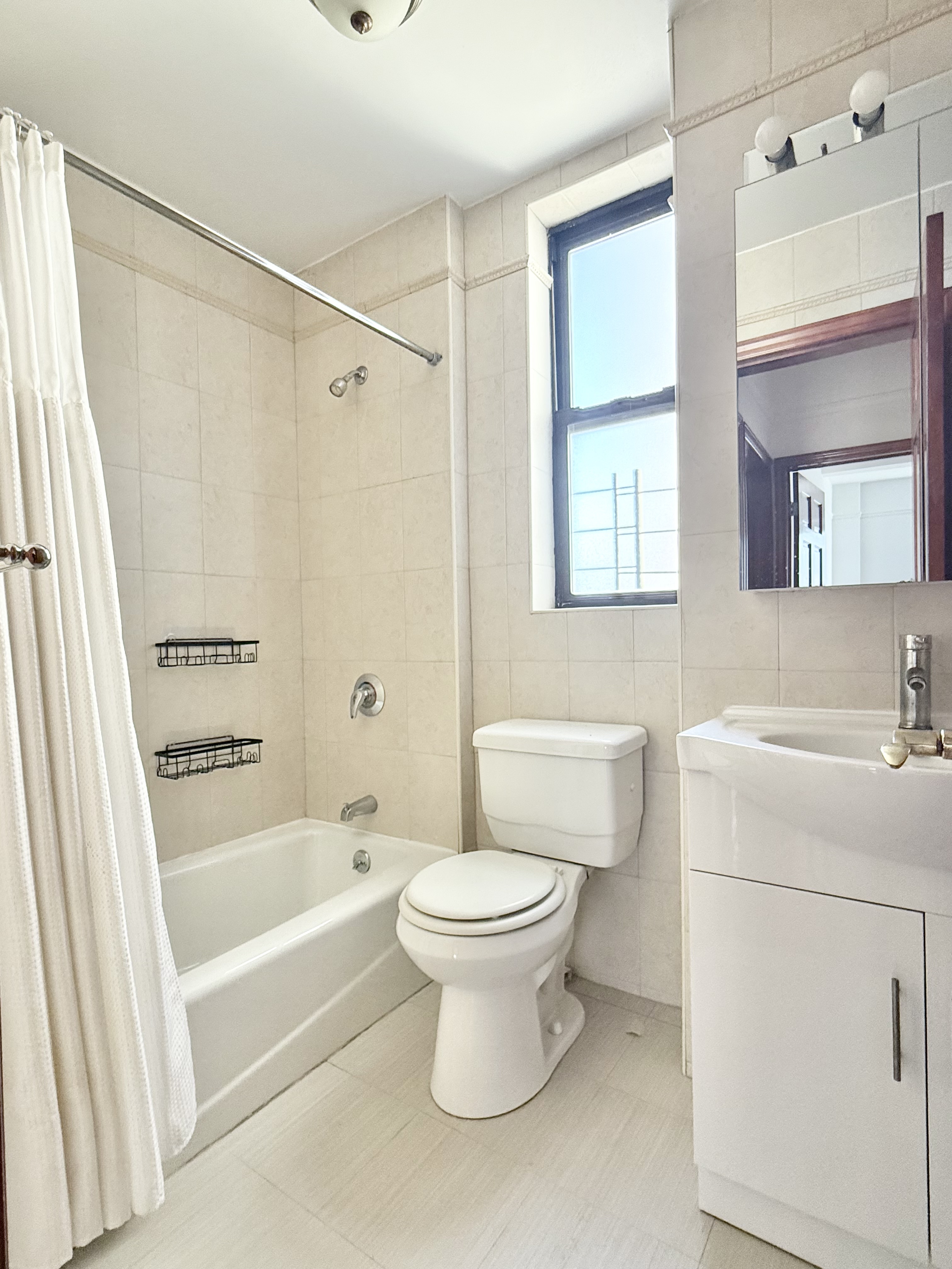 675 West End Avenue, Unit 12A Manhattan, NY 10025 - Photo 12 of 15 a bathroom with a sink toilet and shower