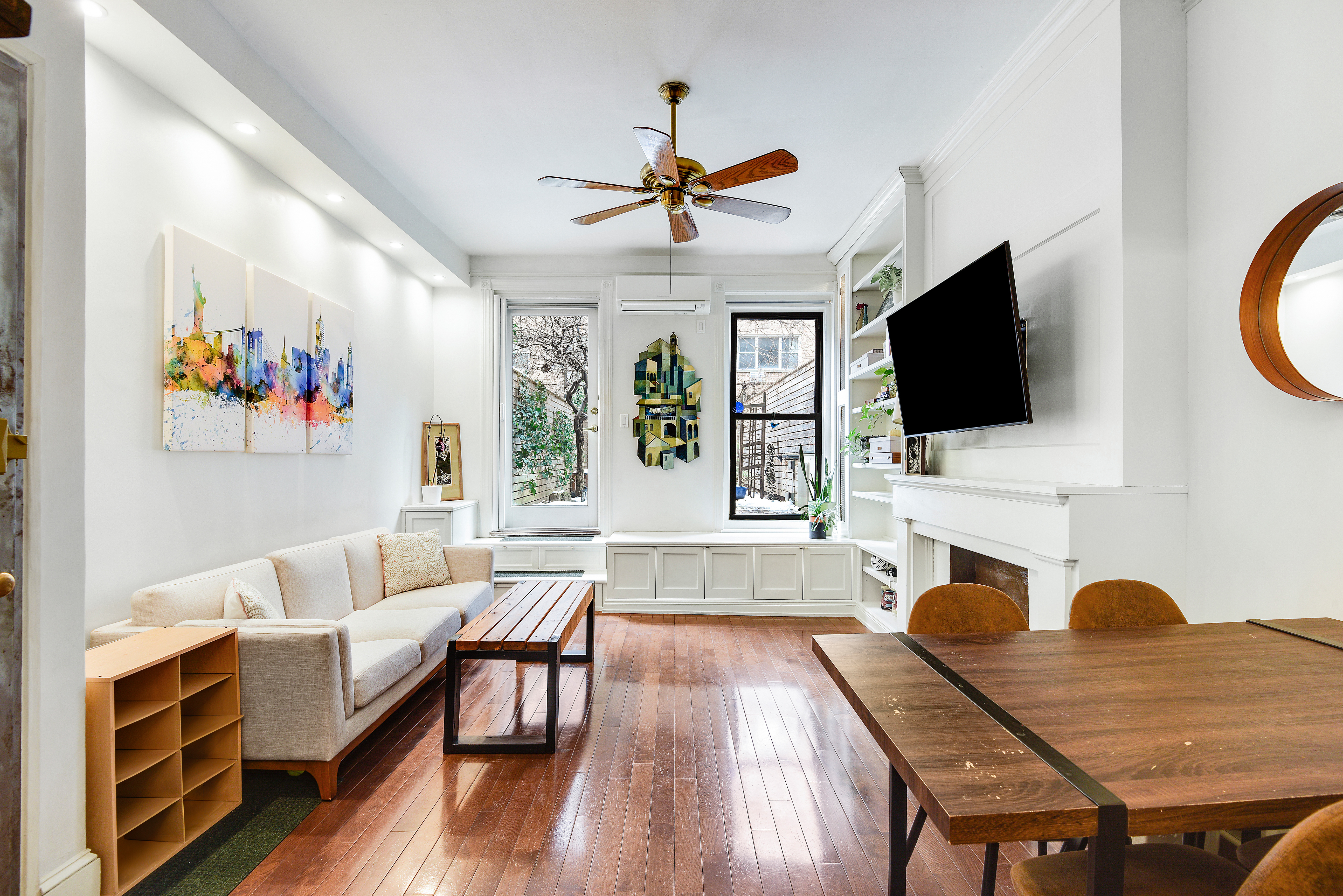 436 East 66th Street, Unit 1W Manhattan, NY 10065 - Photo 4 of 19 a living room with furniture and a flat screen tv