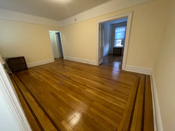 a view of a room with wooden floor and chair