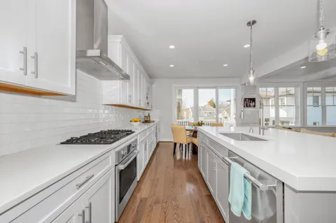 a stove top oven sitting inside of a kitchen