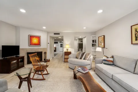 a living room with furniture and a lamp