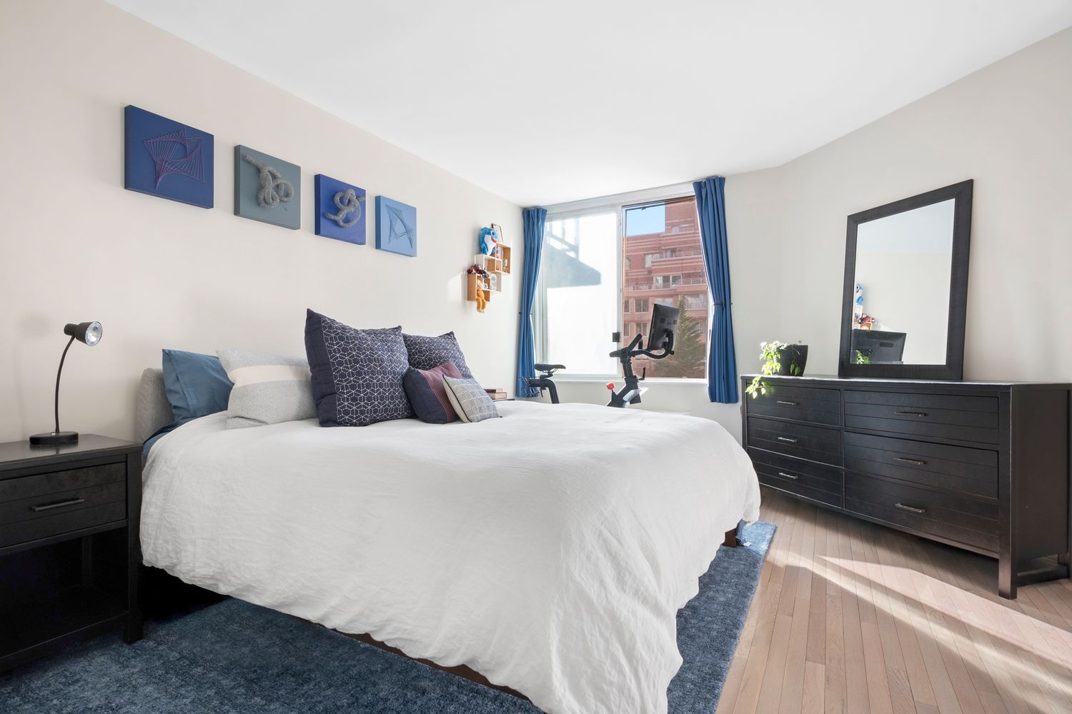 a bedroom with a large bed and a dresser