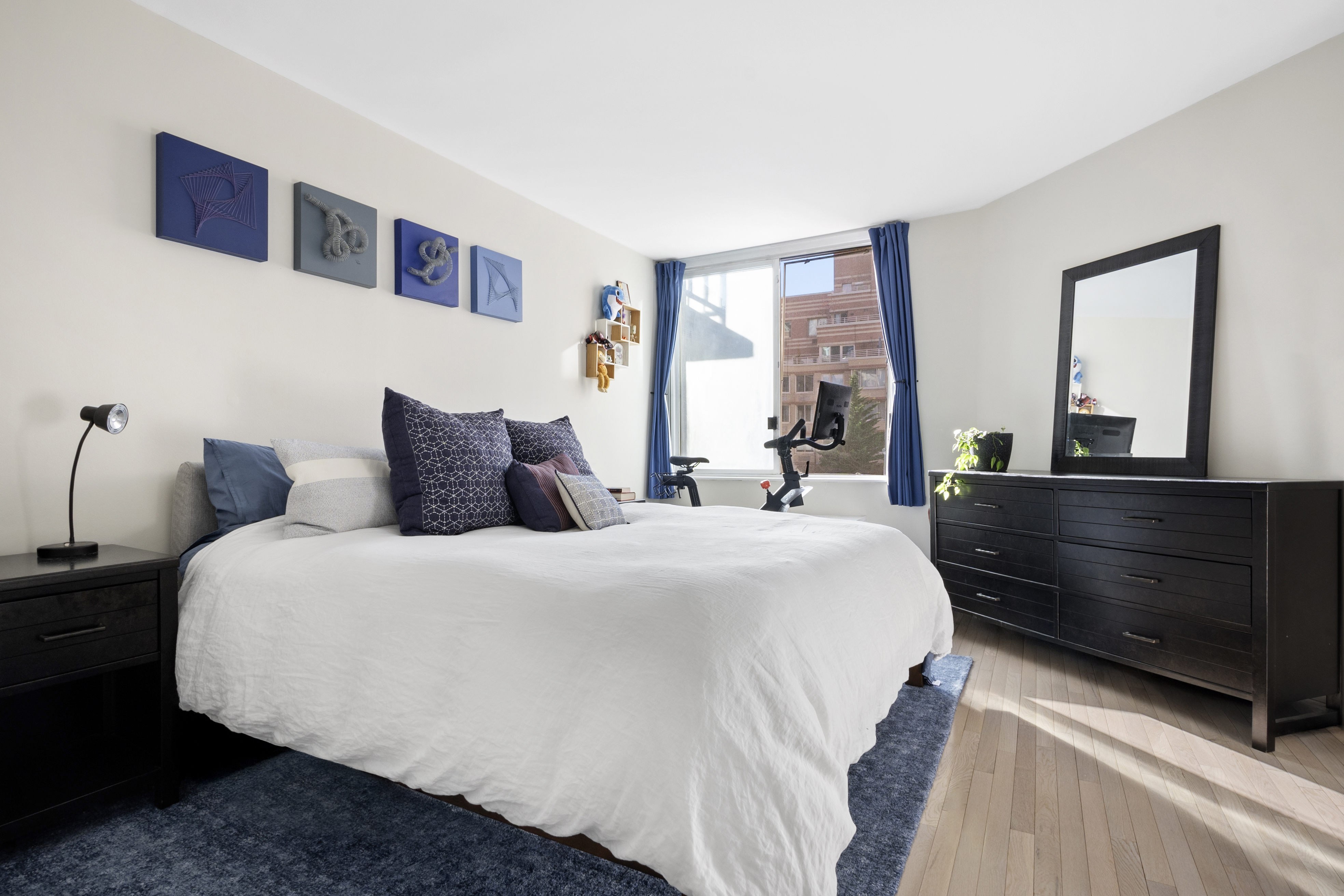 350 West 50th Street, Unit 3LL Manhattan, NY 10019 - Photo 4 of 15 a bedroom with a large bed and a dresser