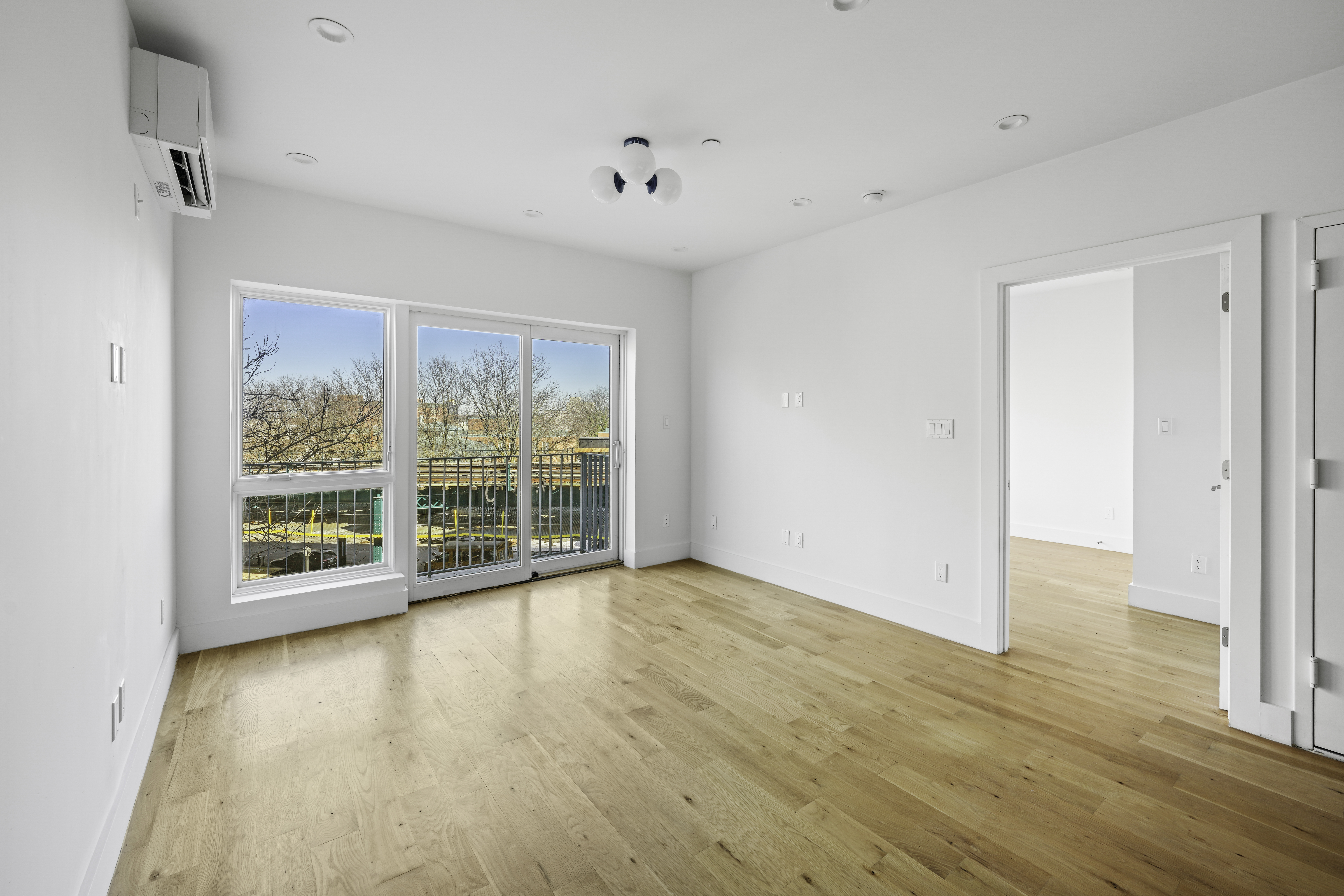 766 Decatur Street, Unit 4A Brooklyn, NY 11233 - Photo 3 of 12 a view of an empty room with wooden floor and a window