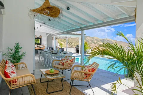 a dining room with furniture and a floor to ceiling window