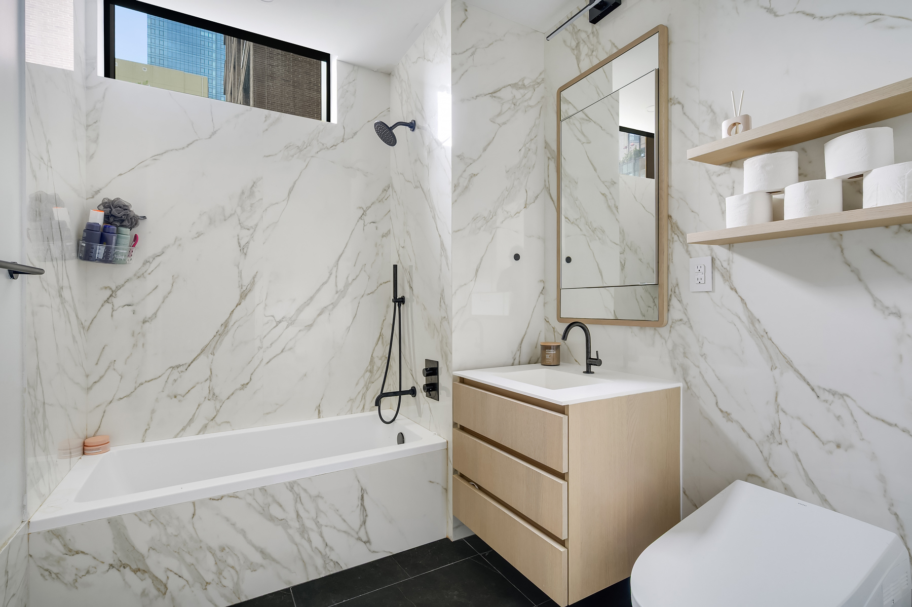 4507 Court Square, Unit 6G Queens, NY 11101 - Photo 4 of 7 a bathroom with a sink a toilet and shower