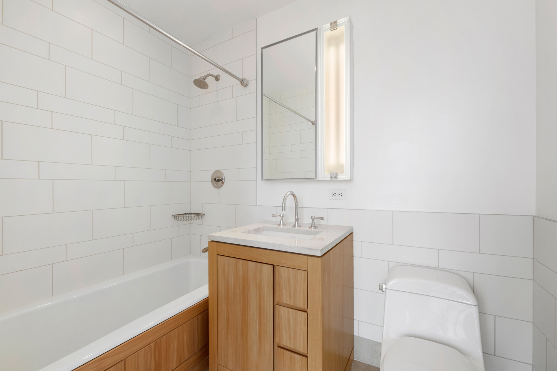 450 East 83rd Street, Unit 23B Manhattan, NY 10028 - Photo 10 of 18 a bathroom with a sink a toilet and bathtub