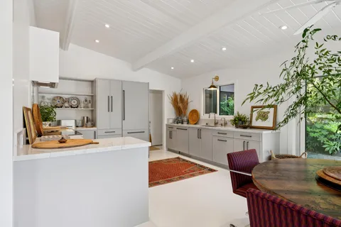 a large kitchen with stainless steel appliances granite countertop a stove a sink and a refrigerator