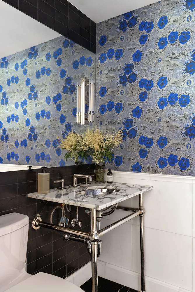 a kitchen with stainless steel appliances kitchen island a stove and a sink