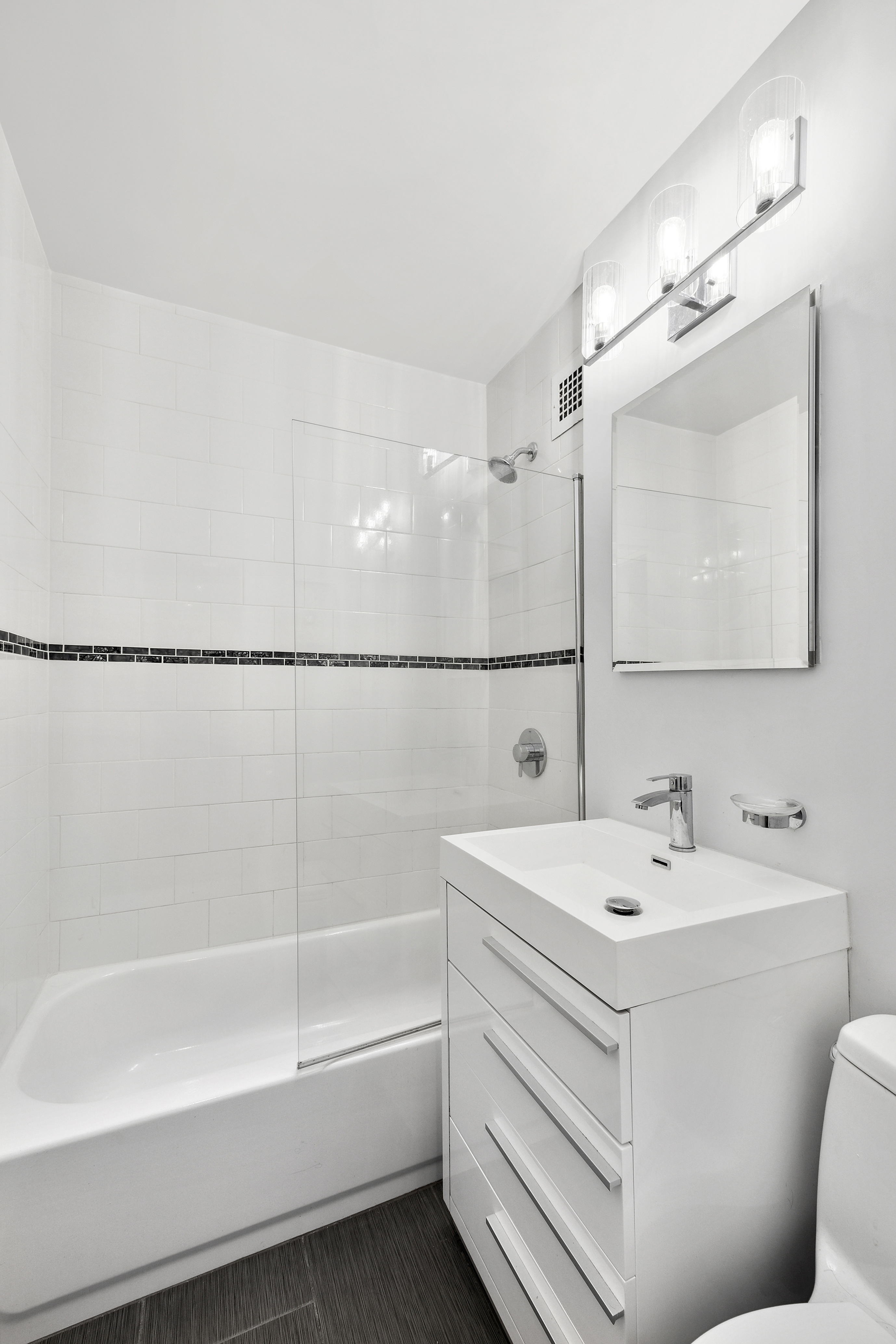 301 East 22nd Street, Unit 6L Manhattan, NY 10010 - Photo 6 of 7 a bathroom with a sink a toilet and bathtub