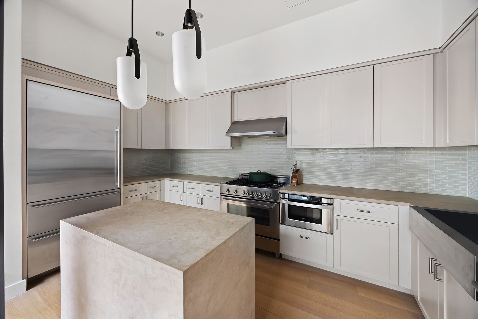 63 Greene Street, Unit PHB Manhattan, NY 10012 - Photo 9 of 17 a kitchen with stainless steel appliances granite countertop a sink a stove and a refrigerator