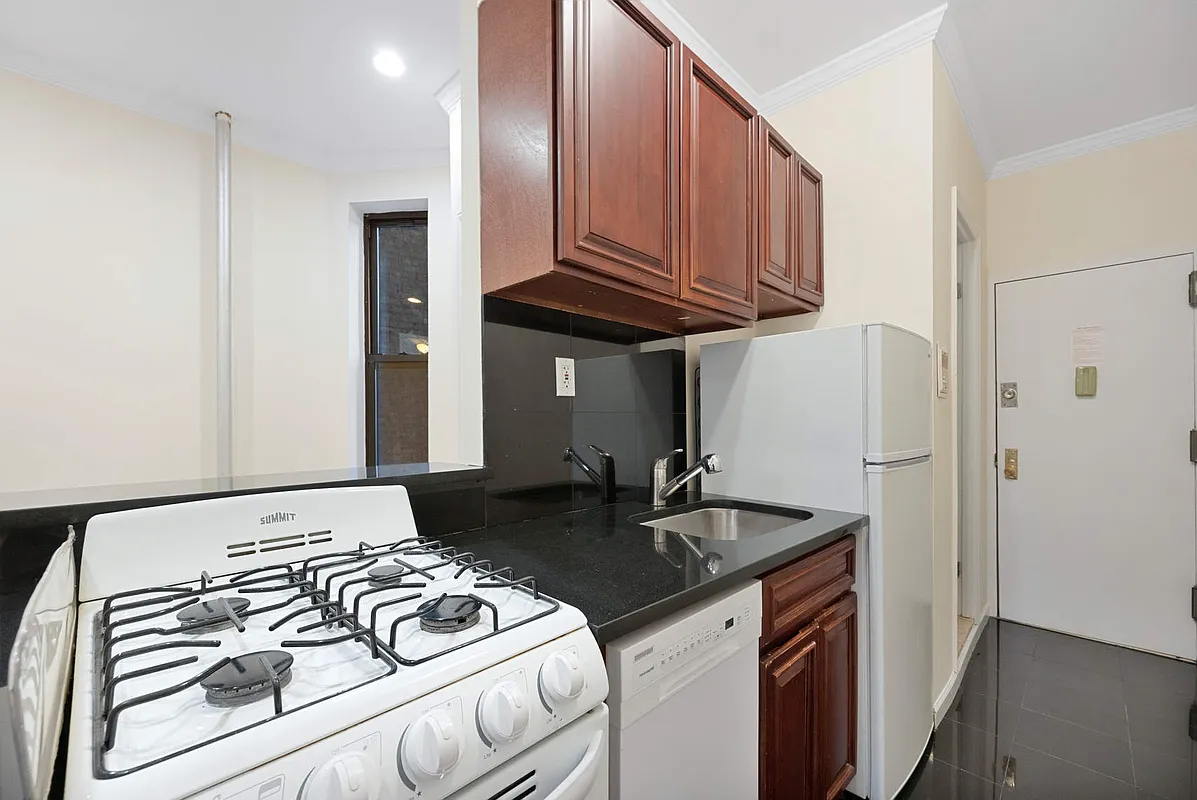 370 Columbus Avenue, Unit 1F Manhattan, NY 10024 - Photo 3 of 11 a kitchen with a sink and a refrigerator