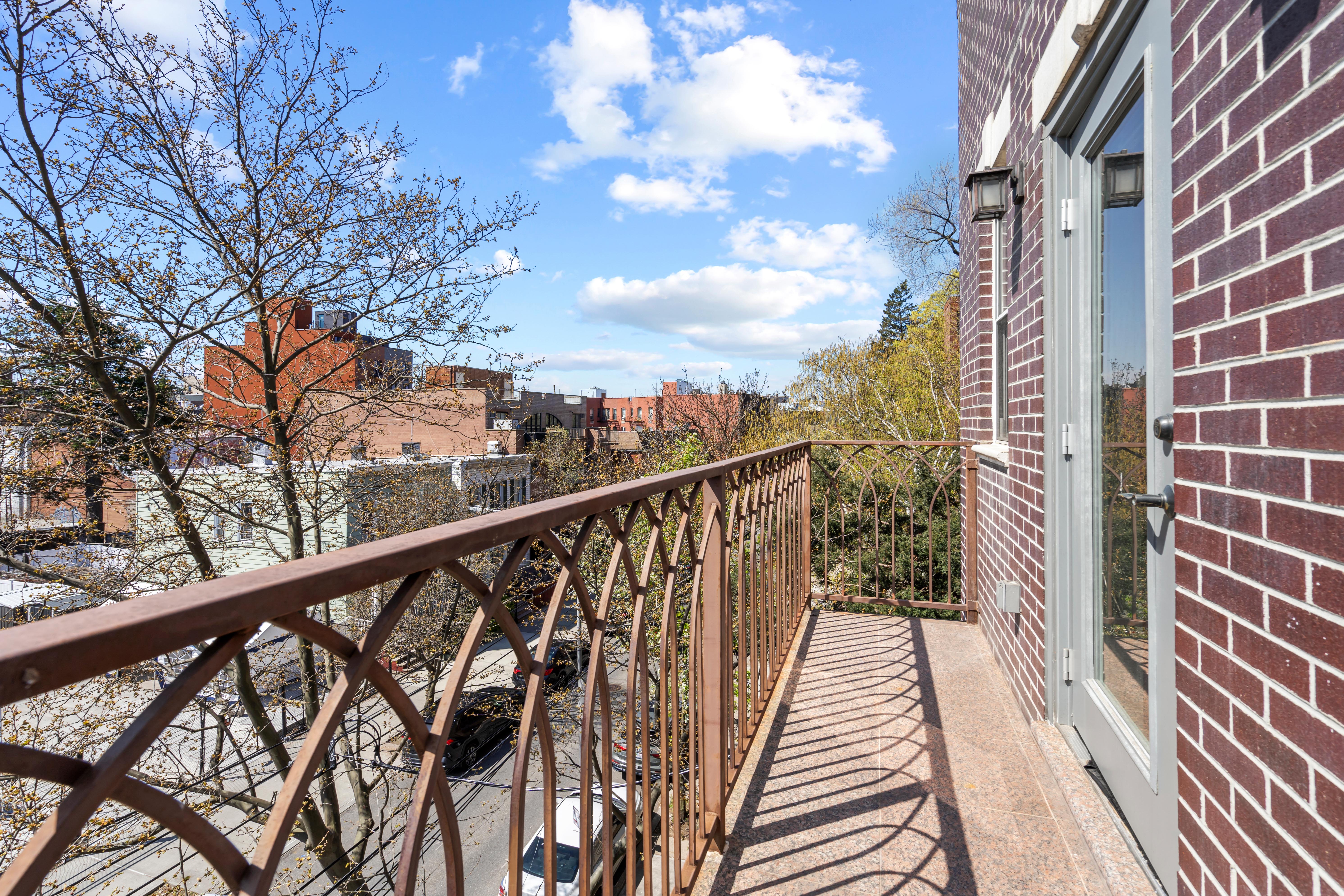 65-33 38th Avenue, Unit 5 Queens, NY 11377 - Photo 16 of 23 a view of balcony with wooden floor and fence
