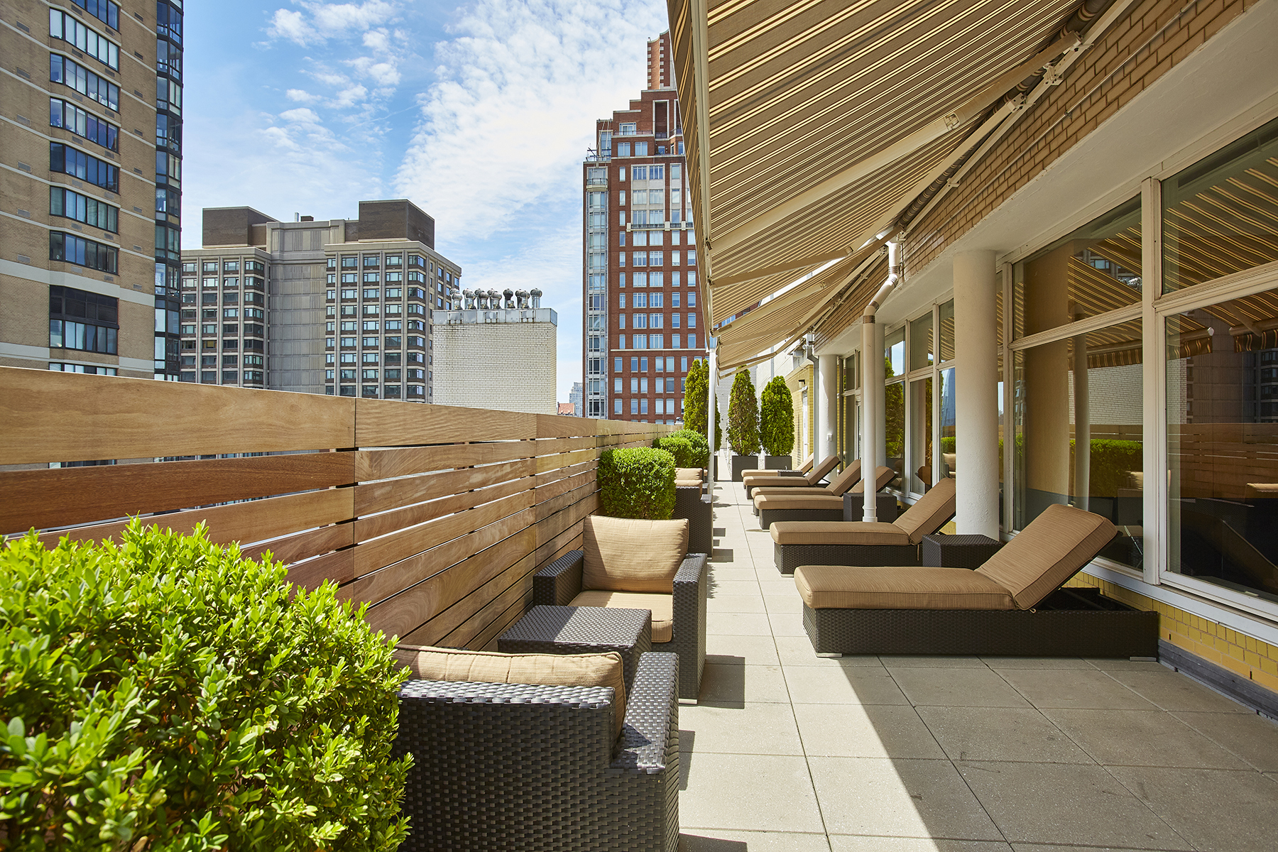 200 East 66th Street, Unit D1004 Manhattan, NY 10065 - Photo 4 of 6 a view of a patio with couches and potted plants