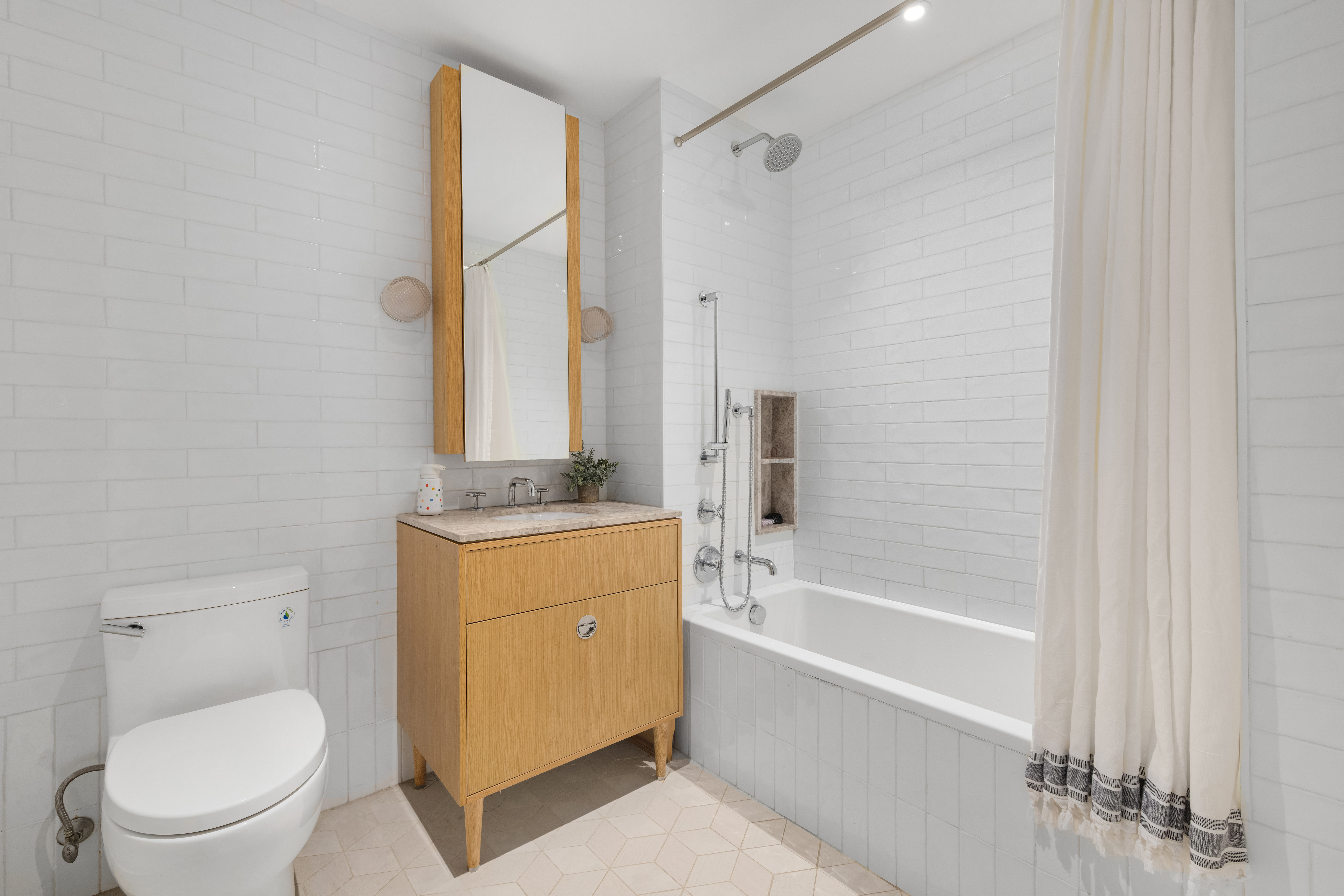 181 18th Street, Unit 204 Brooklyn, NY 11215 - Photo 6 of 15 a bathroom with a granite countertop sink a toilet and shower