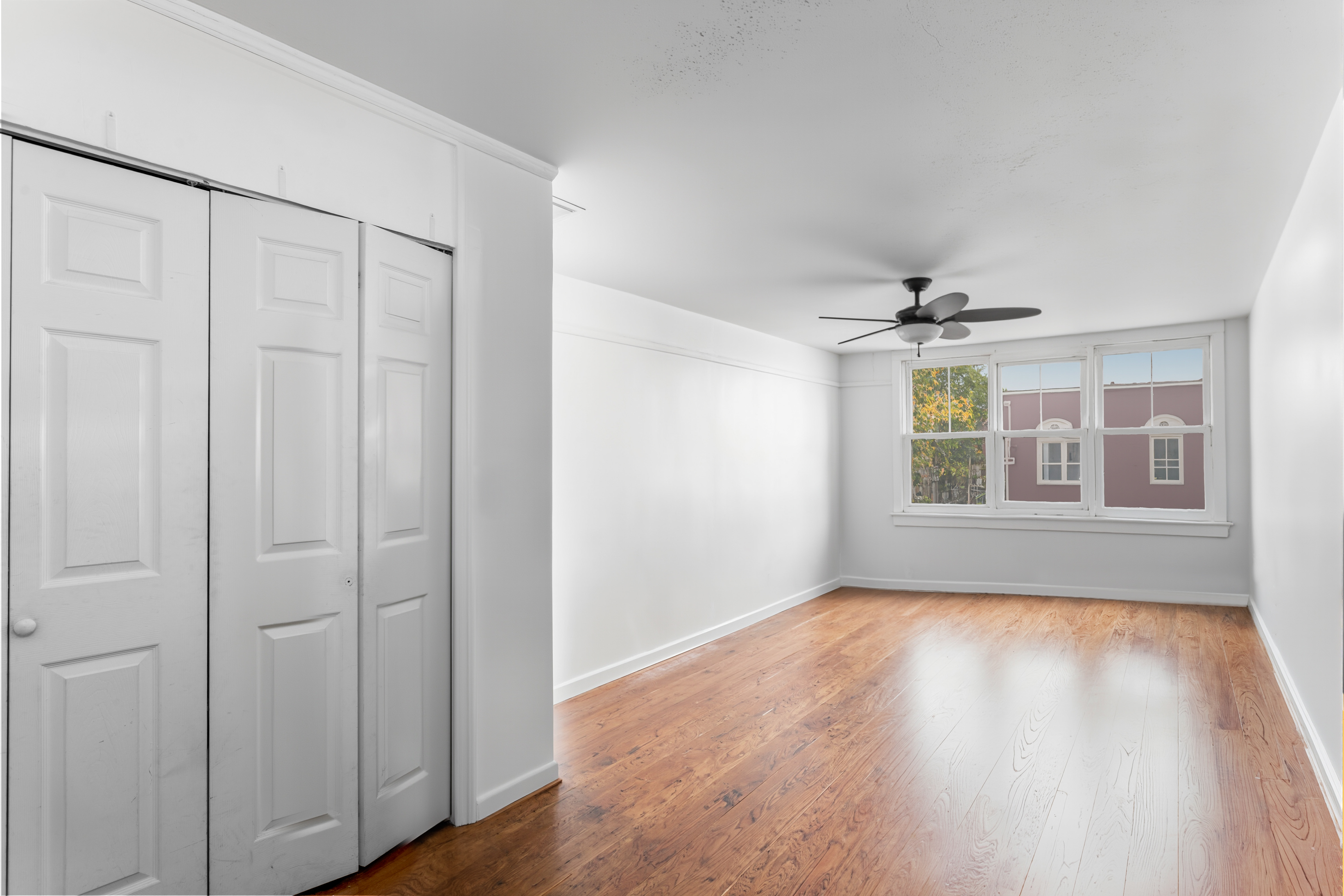 227 Ocean Parkway, Unit 7F Brooklyn, NY 11218 - Photo 1 of 7 a view of an empty room with wooden floor and a window