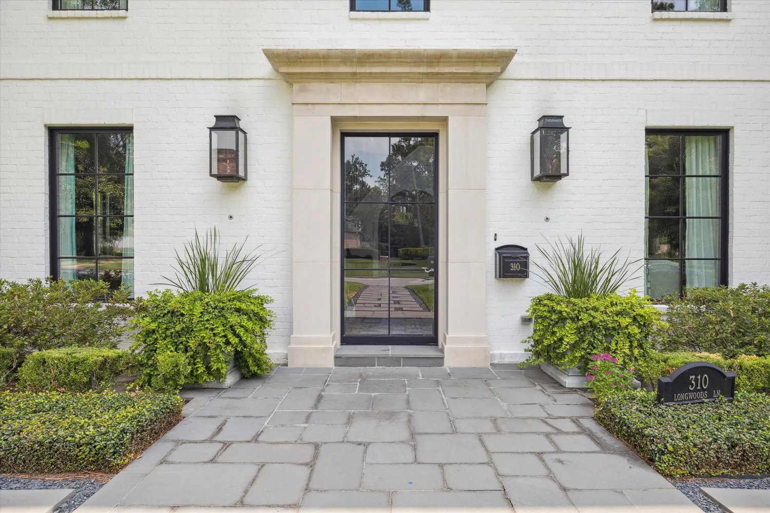 a front view of a house with garden