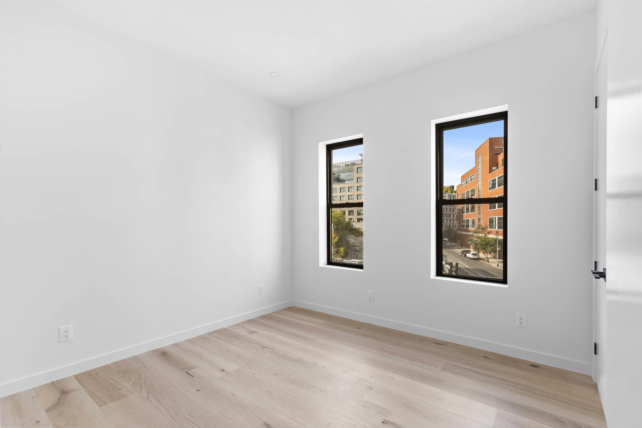92 Jefferson Street, Unit 4 Brooklyn, NY 11206 - Photo 6 of 9 an empty room with windows