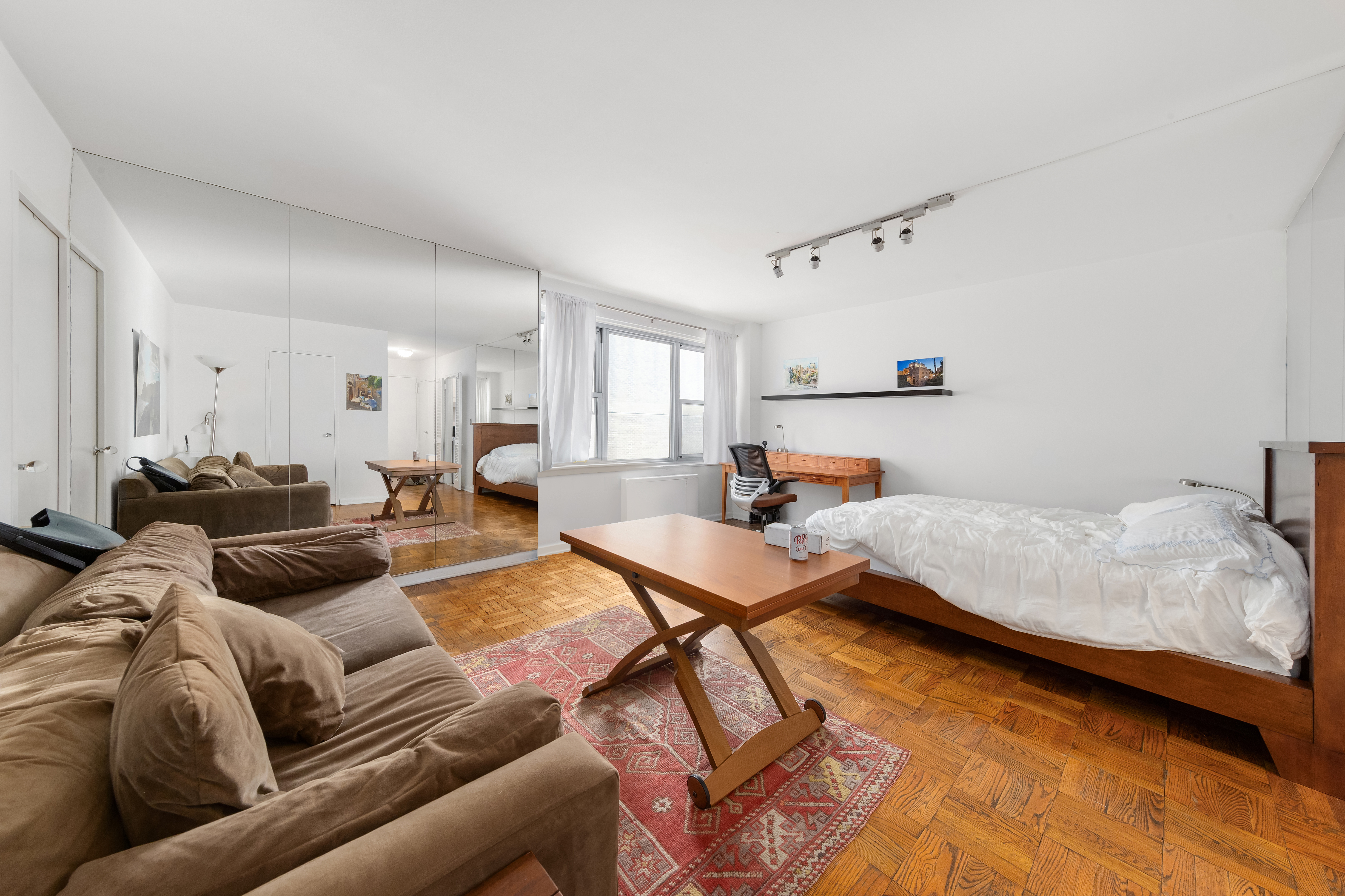 77 West 55th Street, Unit 16A Manhattan, NY 10019 - Photo 5 of 6 a living room with furniture and kitchen view