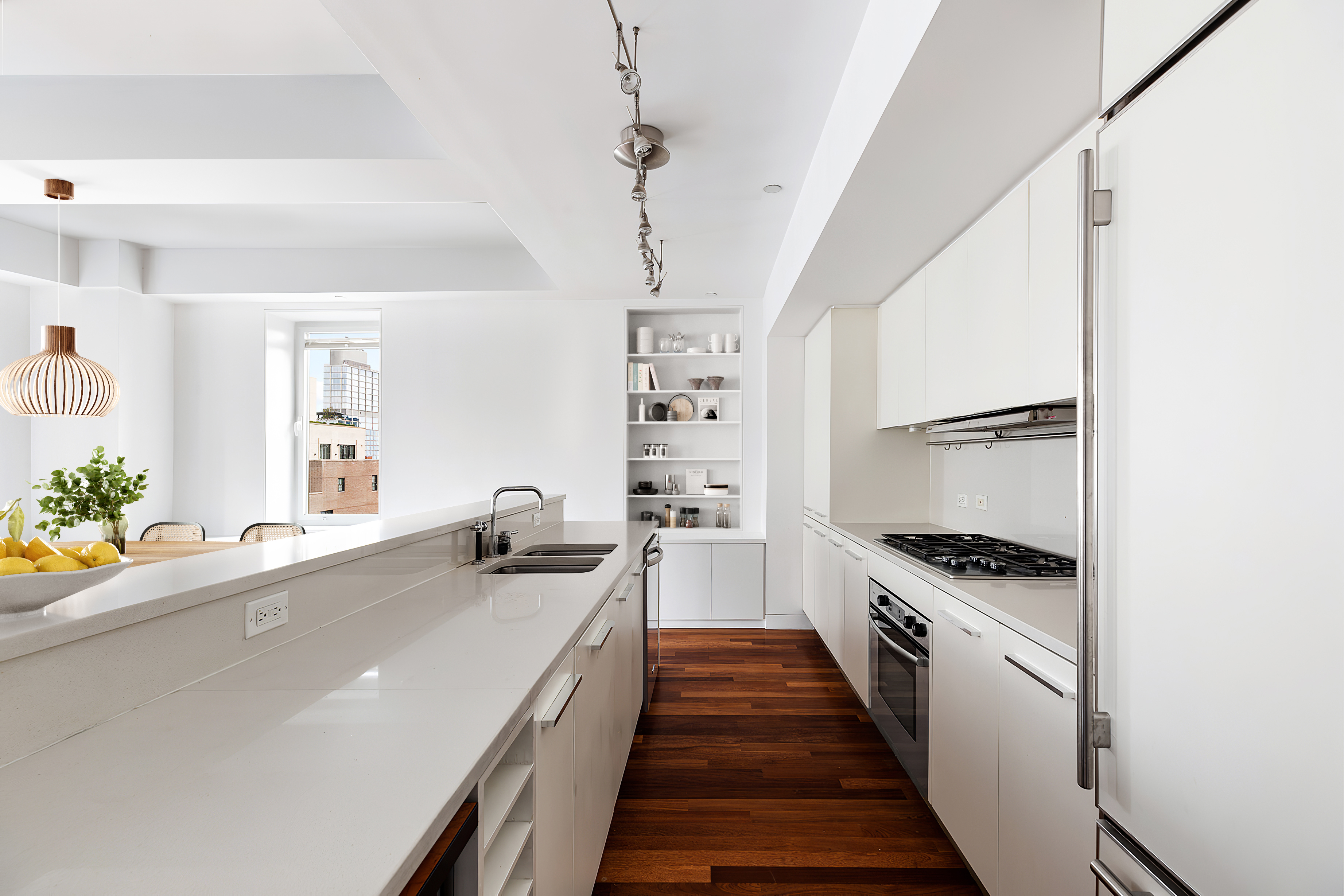 225 Lafayette Street, Unit 10D Manhattan, NY 10012 - Photo 3 of 14 a kitchen with granite countertop a sink stove and refrigerator