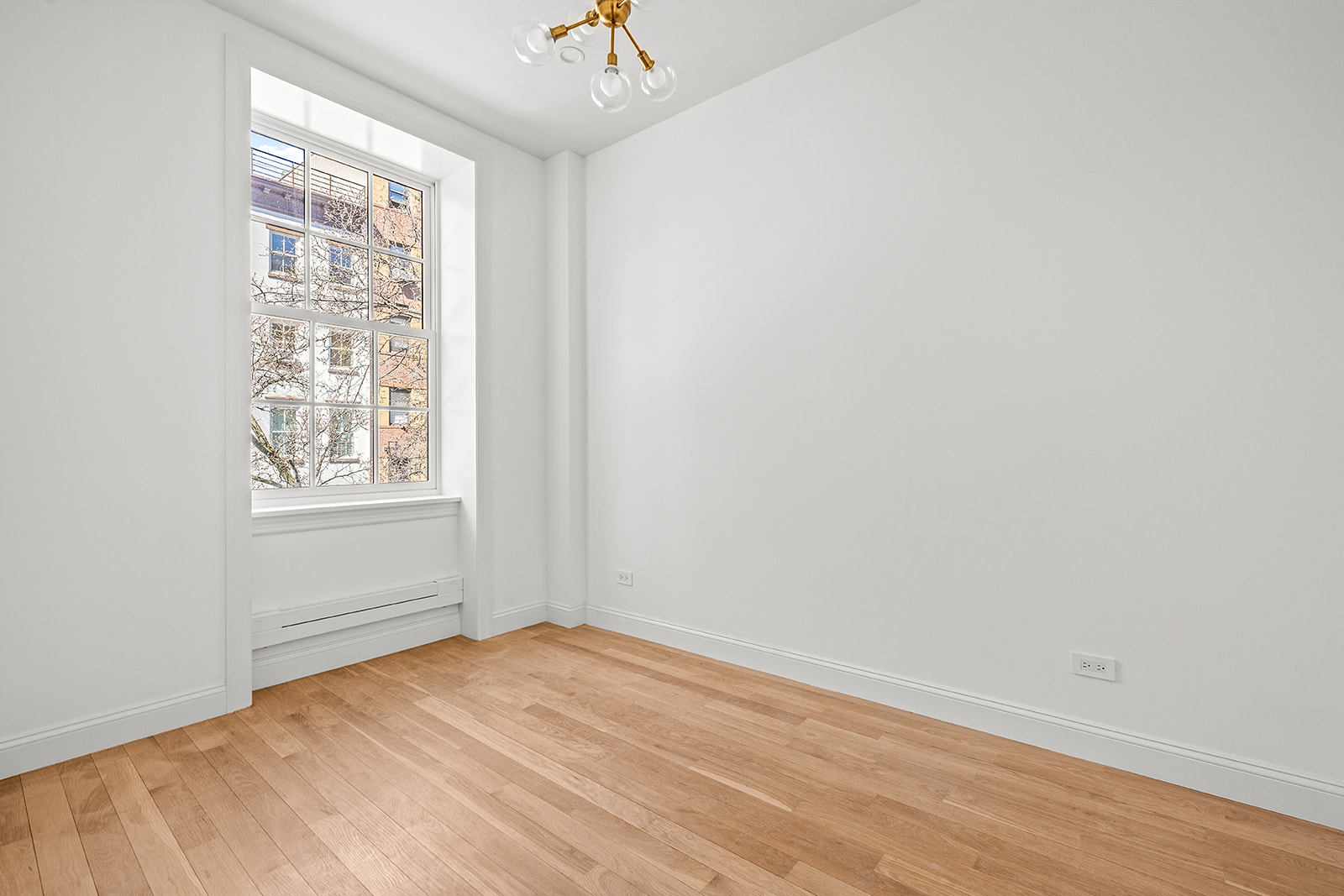119 Henry Street, Unit 3 Brooklyn, NY 11201 - Photo 9 of 14 an empty room with wooden floor and windows