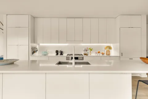 a kitchen with a sink and a refrigerator