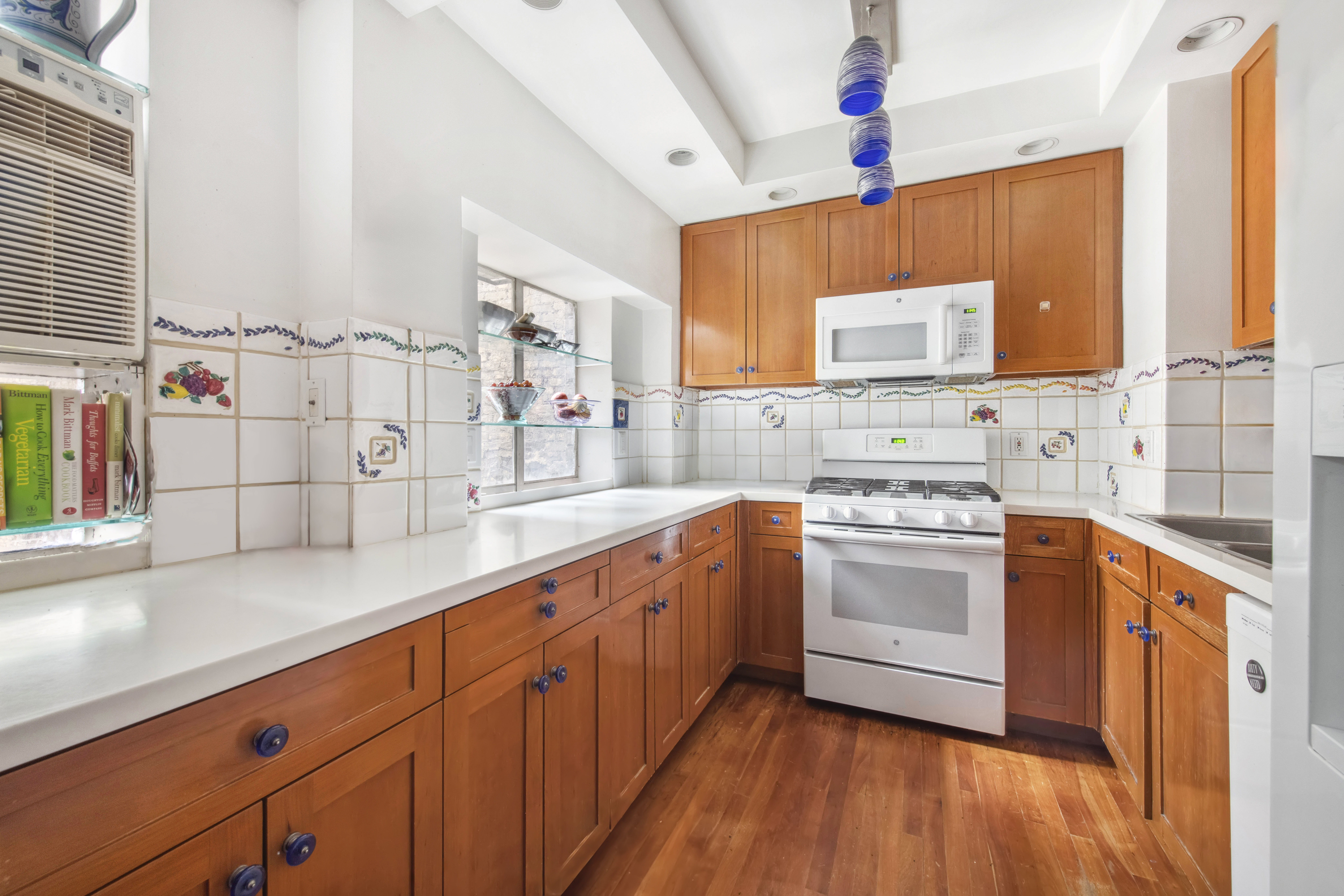 45 West 54th Street, Unit 3CD Manhattan, NY 10019 - Photo 4 of 14 a kitchen with stainless steel appliances granite countertop a sink stove and cabinets